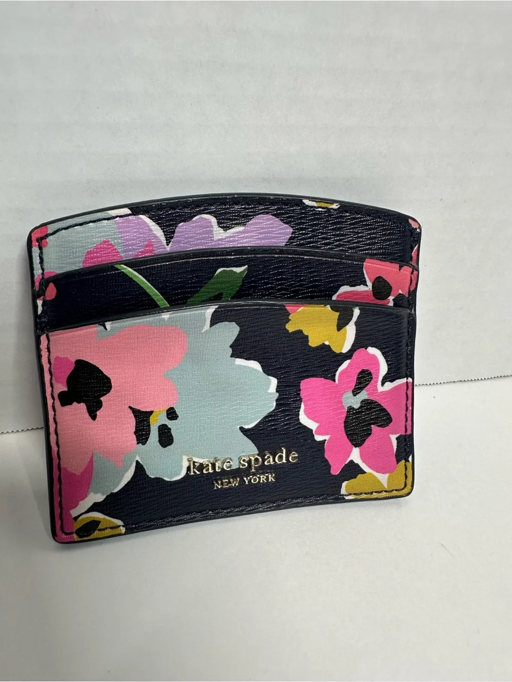 kate spade navy floral card case with pink, light blue and yellow blooms